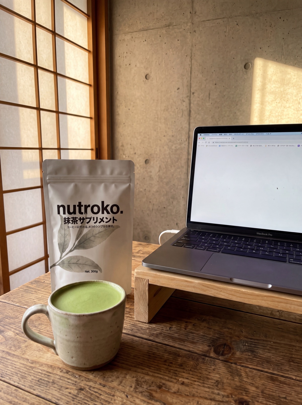 Milk poured into the whisked matcha at a morning desk